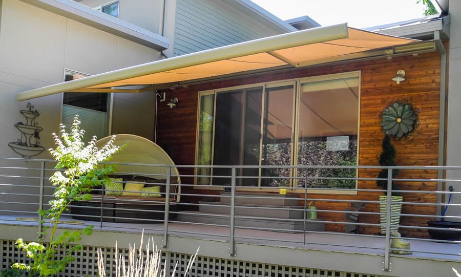 This retractable awning extends 11'8" over the deck, and spans 20'.